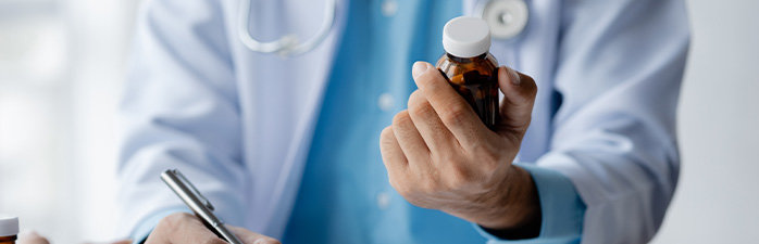 Pharmacist looking at medication bottle